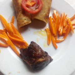 A picture of Grilled beef steak,white chapati and buttered corrots.