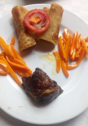 A picture of Grilled beef steak,white chapati and buttered corrots.