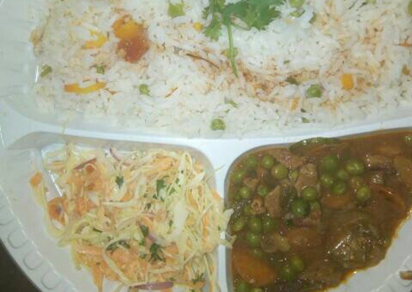 Vegetable rice and beef stew served with coslaw salad