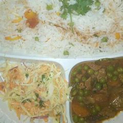 A picture of Vegetable rice and beef stew served with coslaw salad.