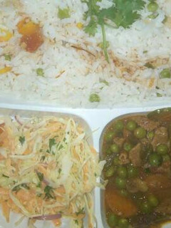 A picture of Vegetable rice and beef stew served with coslaw salad.