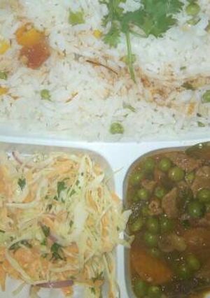 A picture of Vegetable rice and beef stew served with coslaw salad.