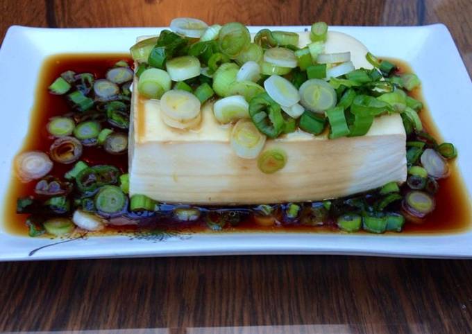 Steamed tofu with sweet soy dressing sauce and spring onions
