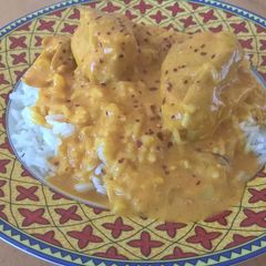 A picture of White rice and chicken curry.