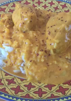 A picture of White rice and chicken curry.