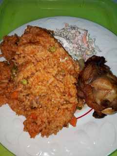A picture of Jollof Rice, Chicken and Salad.