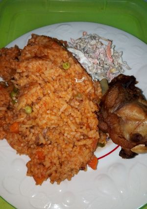 A picture of Jollof Rice, Chicken and Salad.