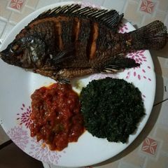 A picture of Fried Fish served with pumpkin leaves.