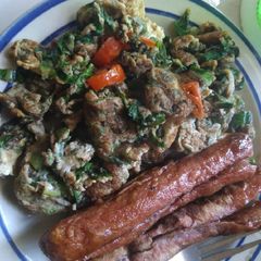 A picture of Vegetable Fried eggs with sausages.