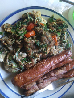 A picture of Vegetable Fried eggs with sausages.