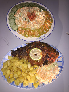 A picture of Grilled fish with french fries and coleslaw.