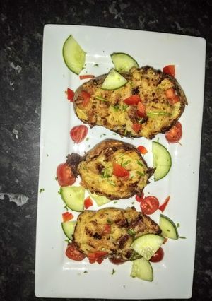 A picture of Bacon Jacket potatoes with cheese and chives.