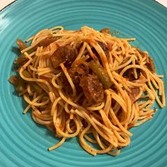 A picture of Sausage and peppers with spaghetti.
