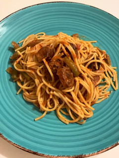 A picture of Sausage and peppers with spaghetti.