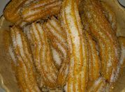 Una foto de churros con leche y manteca
