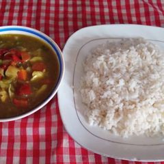 A picture of Rice and chicken sauce.