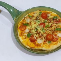 A picture of Paneer, cherry tomato,cheese, capsicum,pizza.