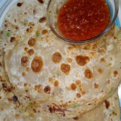 A picture of Alo ke parathy with lahsan ki chutney.