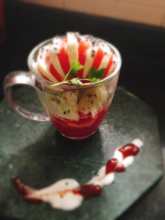 A picture of Layered Cup Caprese Salad with Curd dressing.