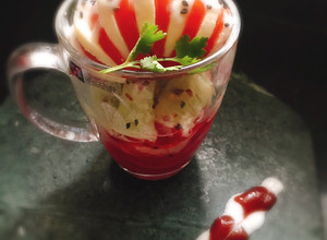 A picture of Layered Cup Caprese Salad with Curd dressing.