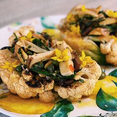 A picture of Cauliflower steak with olive pistu and porcini mushrooms💛.