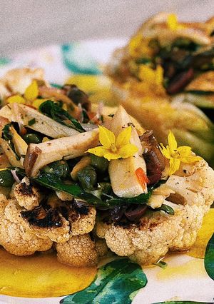 A picture of Cauliflower steak with olive pistu and porcini mushrooms💛.