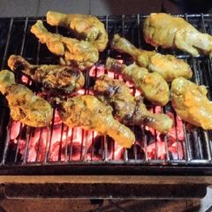 A picture of Chicken paprika drums Skewered red hot Shrimps and grilled sausages.