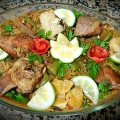 A picture of Meat paella and chicken, fish.