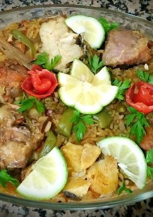 A picture of Meat paella and chicken, fish.