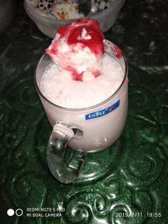 A picture of Strawberry shake with ice cream.