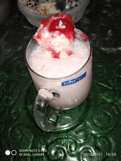 A picture of Strawberry shake with ice cream.