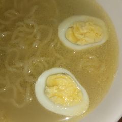 A picture of Chicken noodle soup with egg.