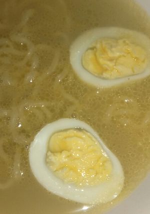 A picture of Chicken noodle soup with egg.