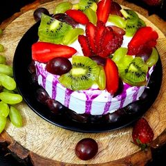 A picture of Fresh Fruit Cake with Whipped cream.