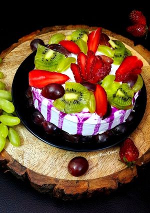 A picture of Fresh Fruit Cake with Whipped cream.