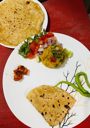 A picture of Masoor Dal Bharta with North Indian Style Chapati and Chatpata Mango Pickle.