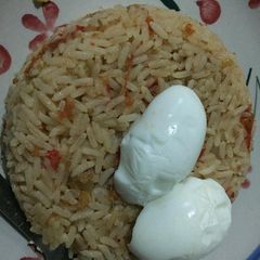 Jollof rice and boiled egg A picture of Jollof rice and boiled egg.