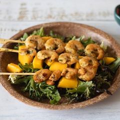 A picture of Spicy Prawns on the skewers with mango salad 🥗 🦐.