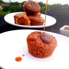 A picture of Gur Muffins with Creamy Jaggery Sauce.