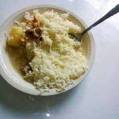A picture of Boiled Rice with Stewed Potatoes and meat.