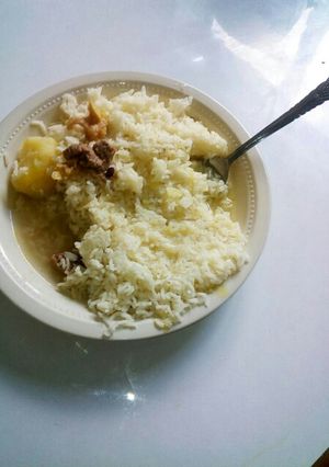 A picture of Boiled Rice with Stewed Potatoes and meat.