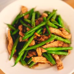 A picture of Stir-fried string beans and pork with sweet soy sauce.