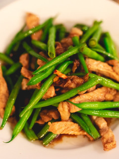 A picture of Stir-fried string beans and pork with sweet soy sauce.