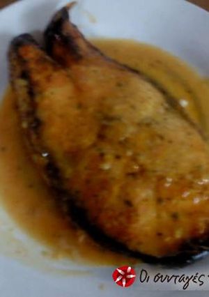 A picture of Grilled salmon with a dressing.