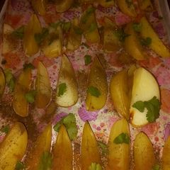A picture of Potato wedges with cinnamon powder and mixed herbs.