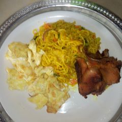 A picture of Turmeric indomi with fried egg and rosted chicken.
