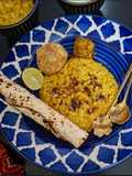 Lemon Lal Msoor Dal Khichdi With Roasted Papad, Chokha, Dahi And Achar
