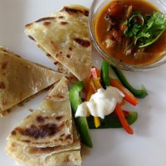 A picture of Soft layered chapati with beef stew.