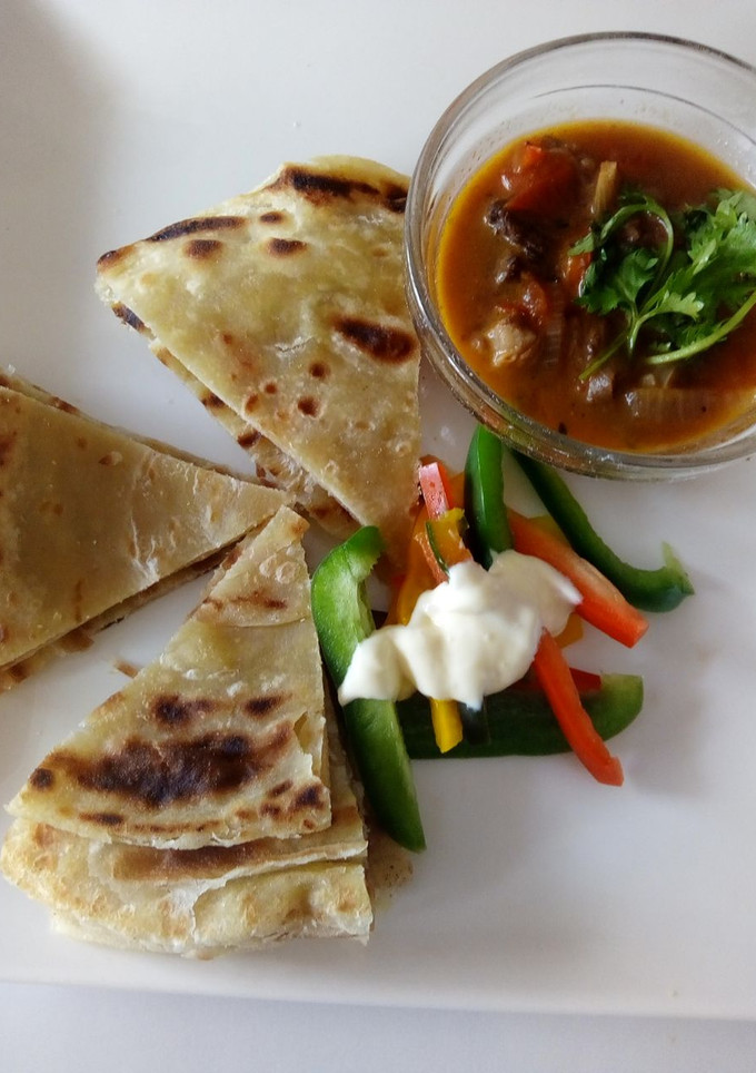 A picture of Soft layered chapati with beef stew.