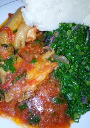 A picture of Chicken Served with Ugali and Kales.